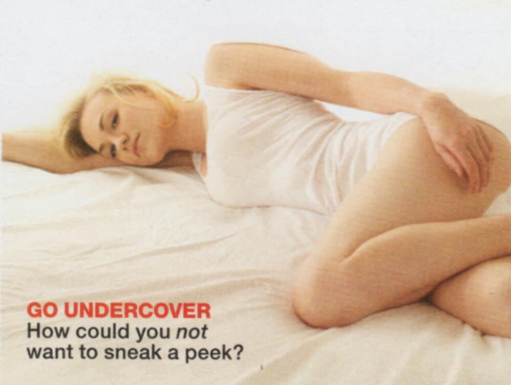 Yvonne Strahovski  is lying on a bed in thshirt and panties