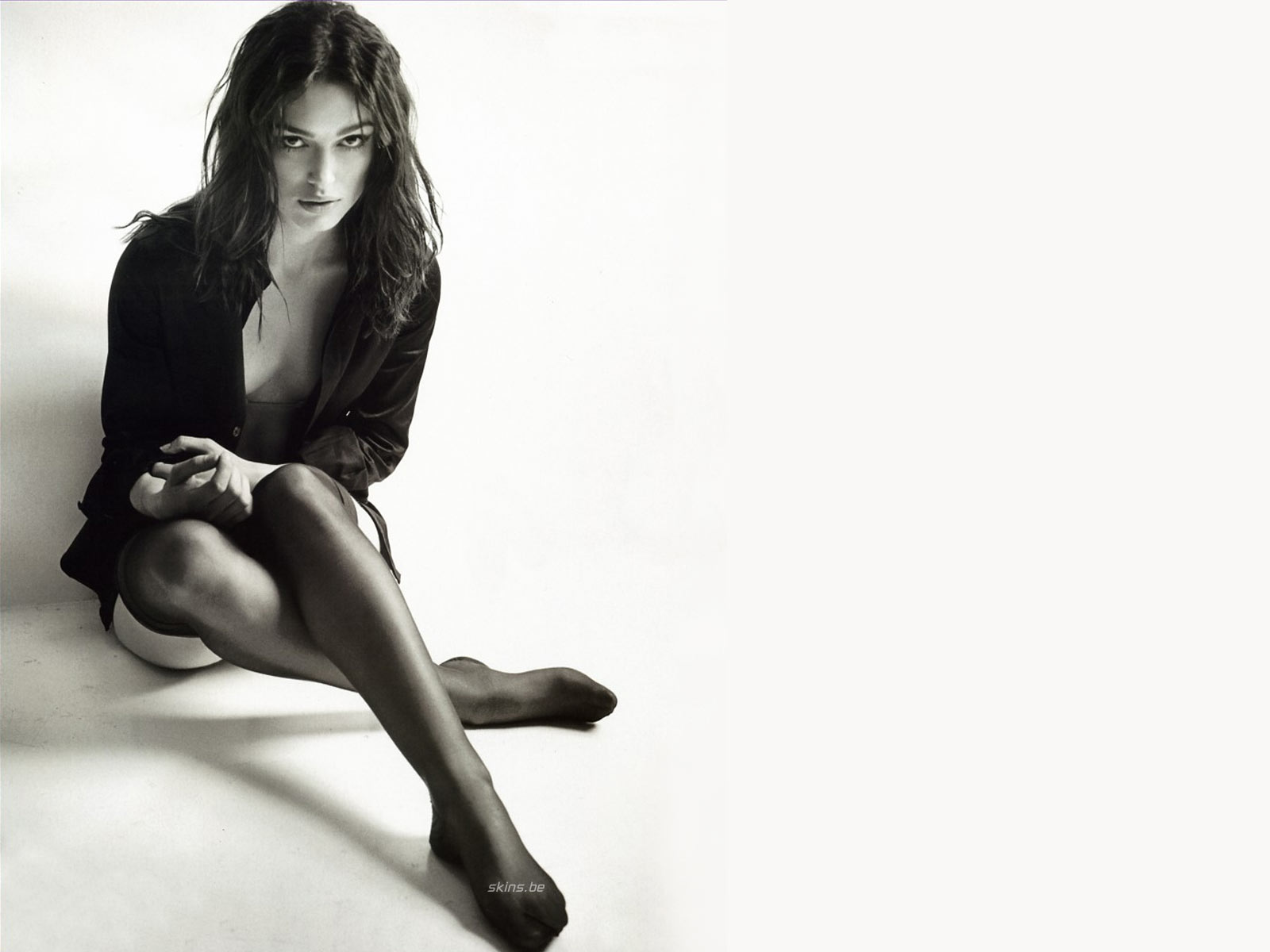 Keira Knightly wears black silk stockings and open black shirt