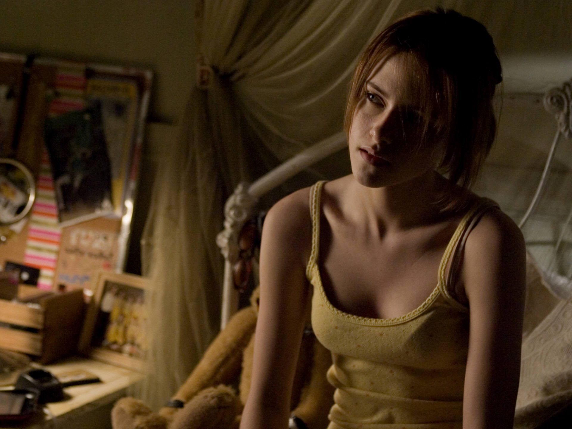 Kristen Stewart in bed in a yellow tank top from The Messengers