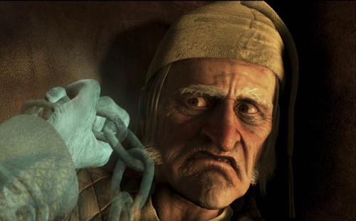 Jim Carey as Ebbenezer Scrooge looks at the ghastly hand of Jacob Marley
